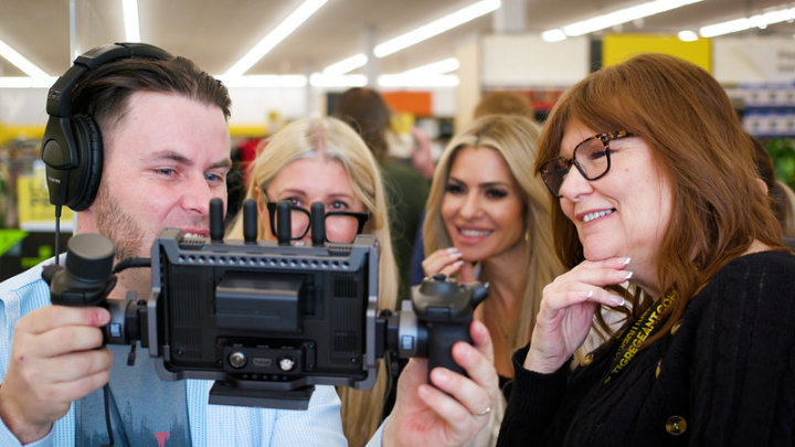 Adam showing video monitor to three leaders